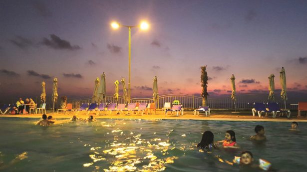 TWILIGHT SWIM
Palestinian kids chill out
before calling it a day