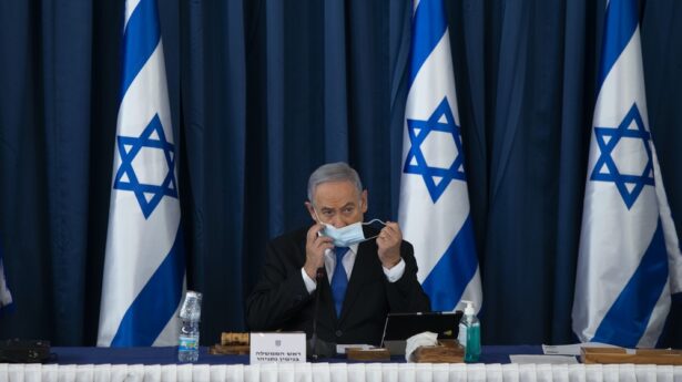 Netanyahu sits alone.