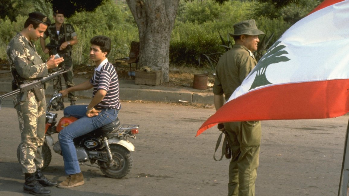 Lebanese Christian soldier mans a checkpoint with an Israeli soldier in 1983.