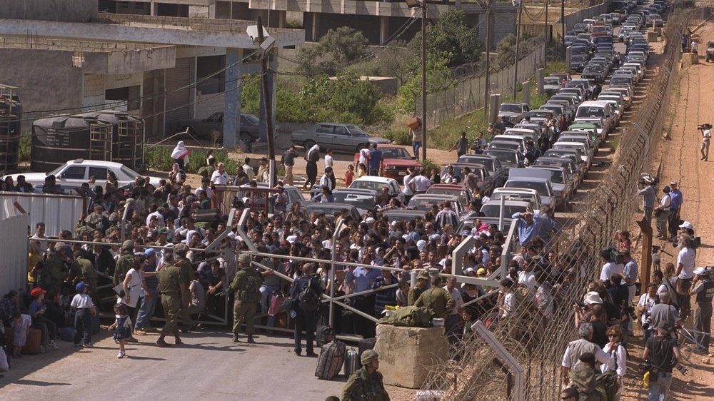 SLA soldiers and their families flee to the Israeli border in May 2000. Israel's sudden withdrawal left many Lebanese Christians angry and confused.