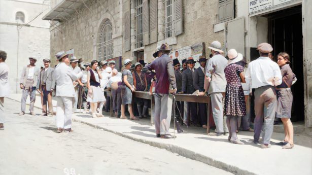 Jews are standing in the line outside the post office waiting to send a telegraph during the 1929 riots.