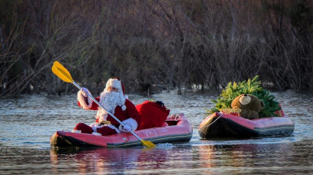 The Holy Land is a little warm for a sleigh and reindeer, so Santa made his way down the Jordan River in a canoe.
