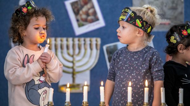Israeli children celebrate Hanukkah at a kindergarten in the center of the country.