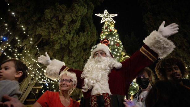 Santa Claus greets guests at the annual Christmas Tree lighting ceremony at the YMCA in downtown Jerusalem.