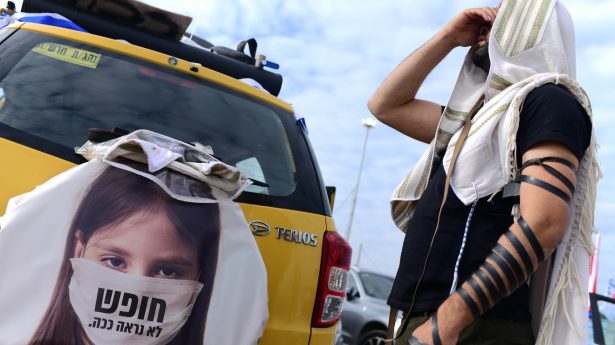 A Jewish man prays before taking part in the Freedom Convoy to Jerusalem on Monday, February 14, 2022.