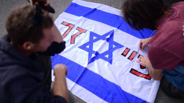 Some say Big Pharma money was behind everything. The flag features the Star of David against the name “Pfizer” in Hebrew.