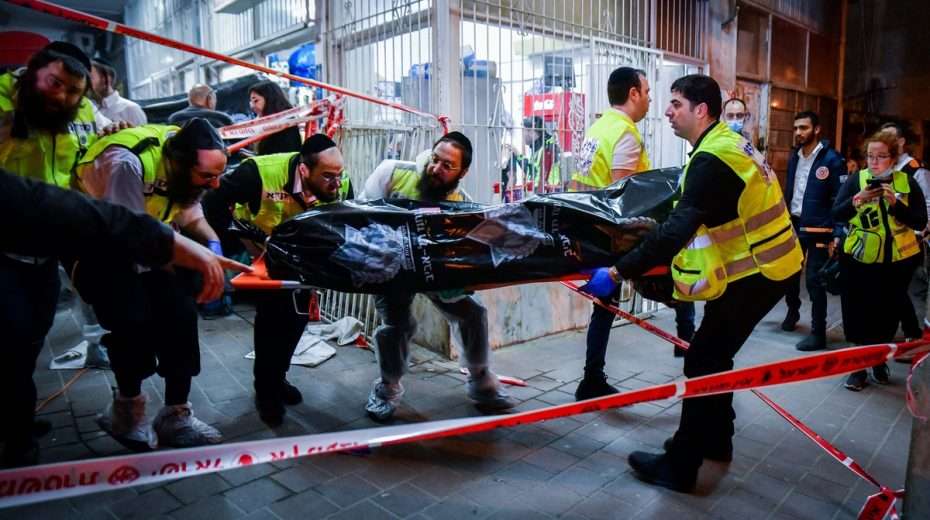 A body is carried away from the scene of the terror attack in Bnei Barak on Tuesday night.