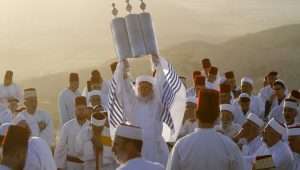 A Samaritan priest raises a Torah scroll at Mount Gerizim in Samaria. These are the "good Jews" that the Palestinians have no problem allowing to remain in the Land.