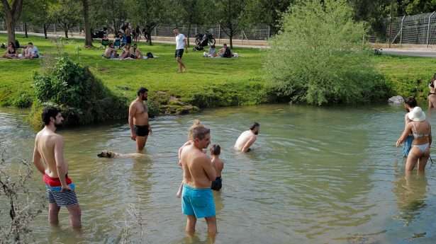 Israelis enjoy a hot day at the Dan River.