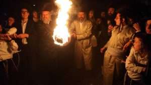 Ultra-Orthodox Jewish men carry a torch to a bonfire during celebrations of the Jewish holiday of Lag B'Omer.