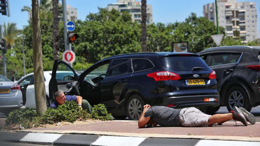 Iranian Hack Likely Set Off Sirens in Jerusalem, Eilat, Say Cybersecurity Experts Israelis take cover as a siren warns of incoming rockets from Gaza, in Ashkelon, on May 19, 2021.