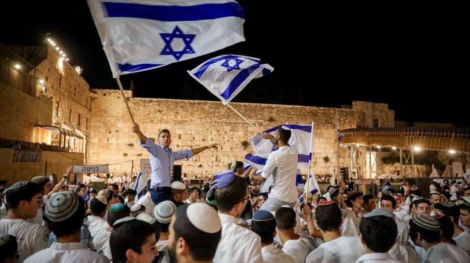 Young Jewish men dance the Hora at the Western Wall in Jerusalem.