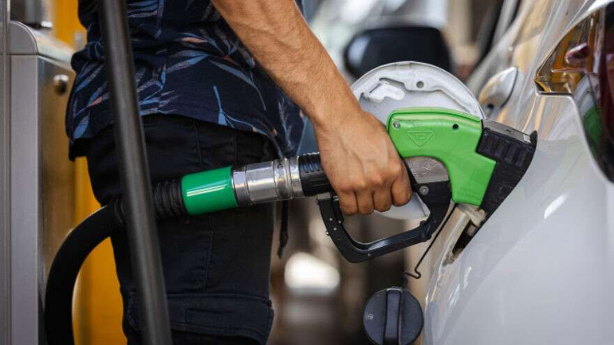 A man pumps gas at a filling station in Jerusalem, on June 28, 2022.