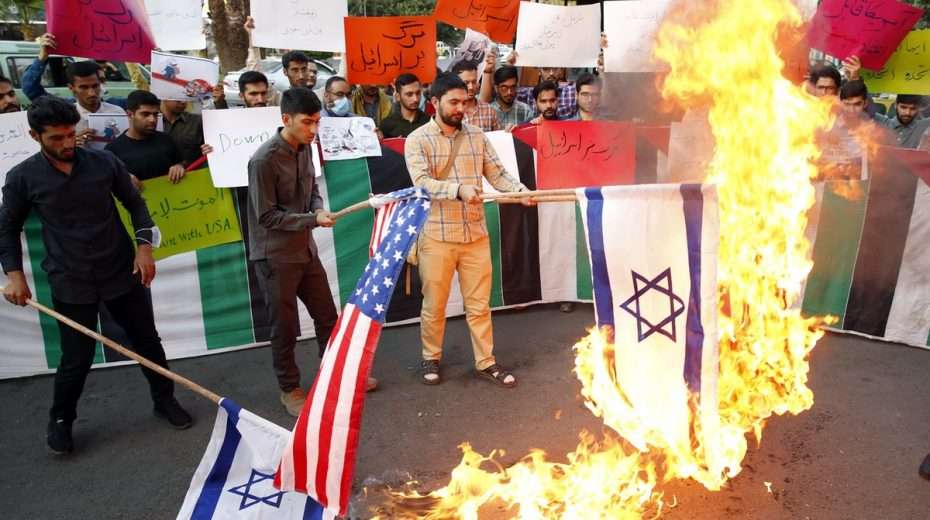 ANALYSIS: Iran Nuclear Negotiations Dead as Mossad Widens Operations Iranian protesting against attempts to halt their nation's nuclear program burn Israeli and US flags on July 16, 2022.