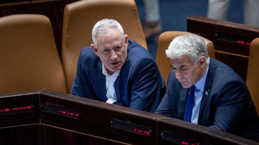 Foreign Minister Yair Lapid and Defense Minister Benny Gantz attend a plenum session at the Knesset in Jerusalem on June 20, 2022.