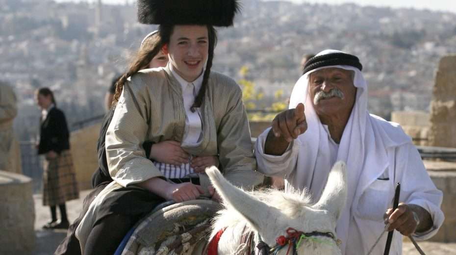 Ultra-Orthodox Jews enjoy a donkey ride from an Arab Muslim on Jerusalem's Mount of Olives.