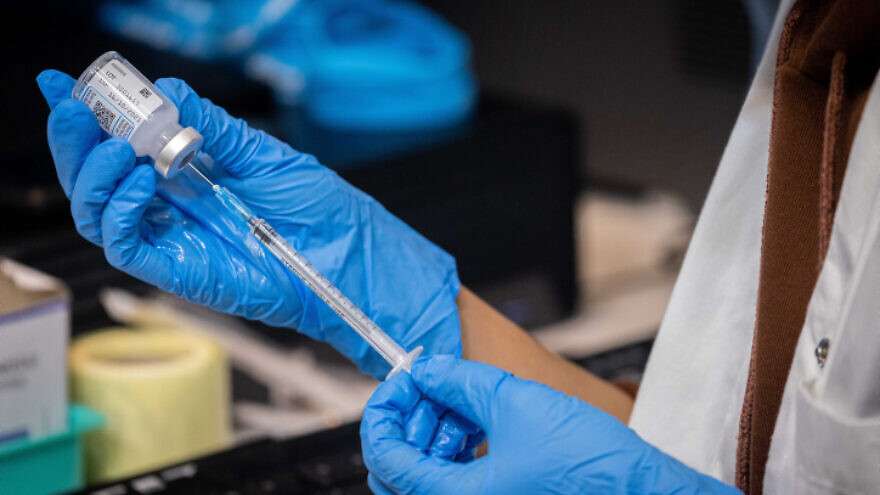An Israeli nurse prepares a COVID-19 vaccine at a temporary clinic in Jerusalem on Sept. 30, 2021.