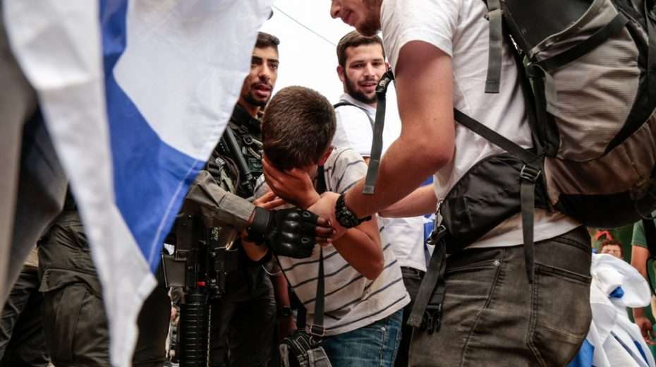 Israeli marcher receiving aid from IDF solders during the Jerusalem Day flag march in the old City.
