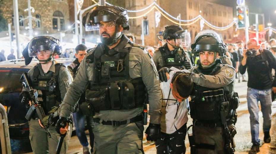 Israeli security forces detain a young Muslim rioter on the streets of Jerusalem.
