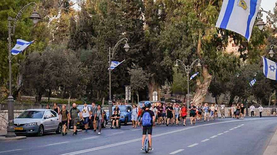 People walk along an empty road in Jerusalem on Yom Kippur, Oct. 9, 2019.