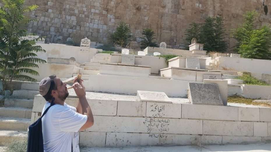 Temple Mount activist Emanuel Brosh blows a shofar near the Golden Gate, leading to his arrest.