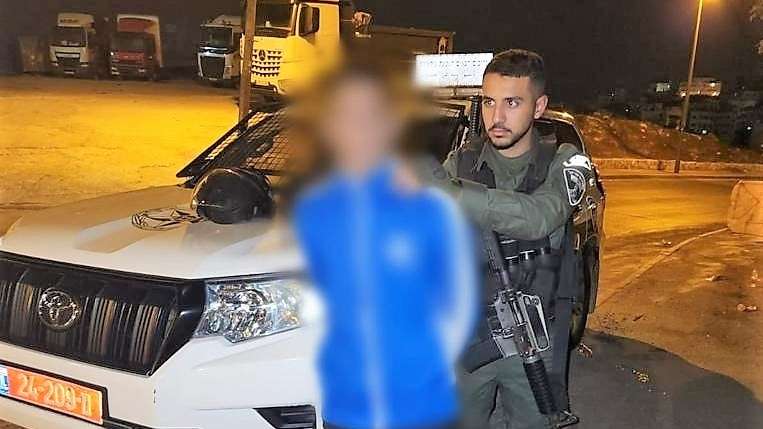 A Muslim rioter is arrested in Jerusalem.
