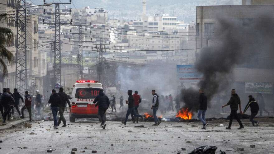 Palestinians clash with Israeli security personnel near Joseph's Tomb in Nablus, April 13, 2022.