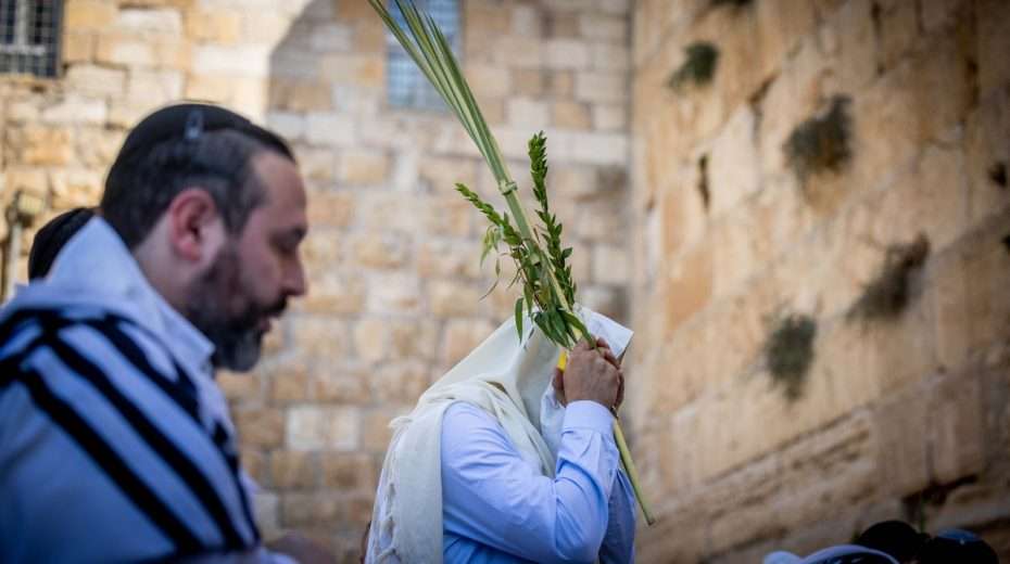 Religious Israelis gather for prayer at the Temple Mount during Sukkot.