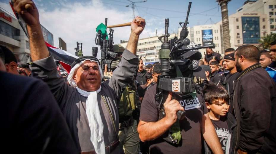 Palestinian gunmen and their supporters on the streets of Nablus, home of the Lions' Den.