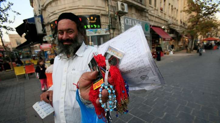 An ultra-Orthodox man holding a small pamphlet that reads "Messiah" selling his wares. How can we effectively promote Yeshua and his gospel when even Messianic Jews engage in promotional fake news?