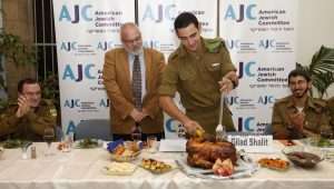 Young American-Israeli soldiers who made Aliyah without family (ie. "Lone Soldiers") are treated to a Thanksgiving meal by the American Jewish Committee.