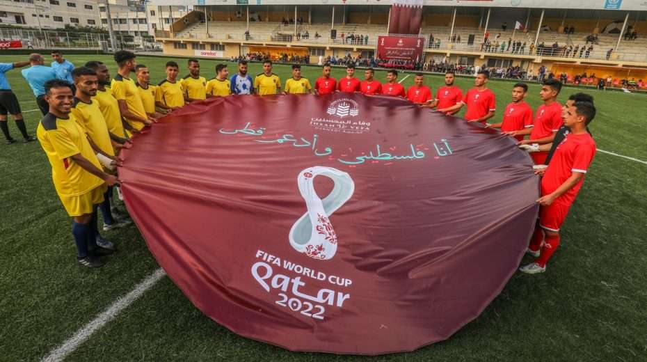 A Palestinian youth team holds the sign of the FIFA World Cup in Qatar, where it is feared Israel's antagonists could target Jewish fans.