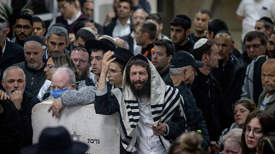 Mourners attend the funeral at the Beit Shemesh Cemetery for Eli and Natalie Mizrahi, who were murdered in the shooting attack in Jerusalem's Neve Ya'akov neighborhood on Friday, Jan. 28, 2023.