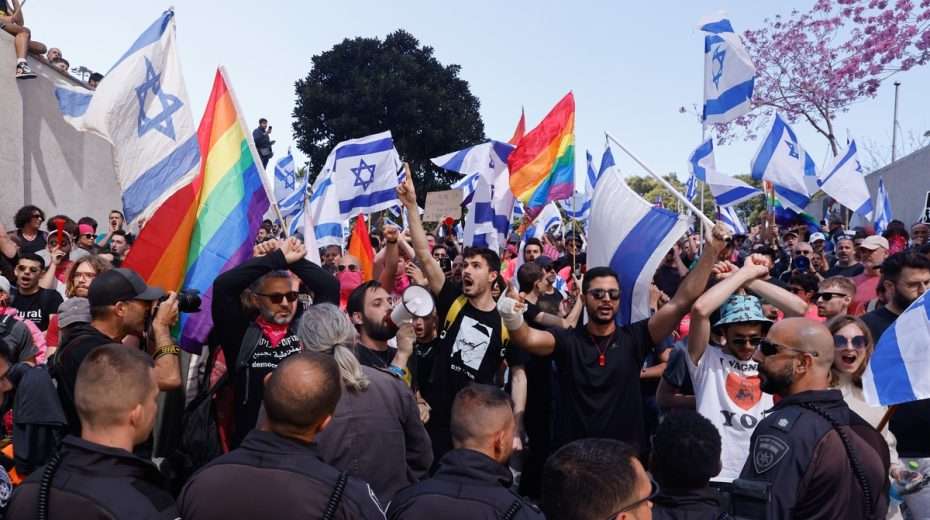 Anti-government protesters clash with police as they block a highway in Tel Aviv.