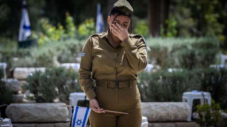 Israeli soldiers place flags on the graves of fallen soldiers at the Mount Herzl Military Cemetery in Jerusalem on April 23, 2023 ahead of Israel's Memorial Day. Photo by Yonatan Sindel/Flash90