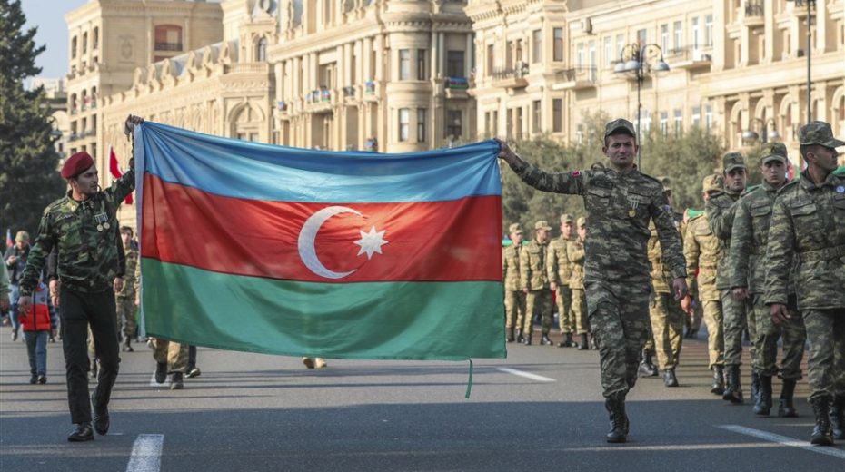 Soldiers carry the national flag of Azerbaijan during a procession through the streets of the capital Baku. Photo by EPA-EFE/ROMAN ISMAYILOV