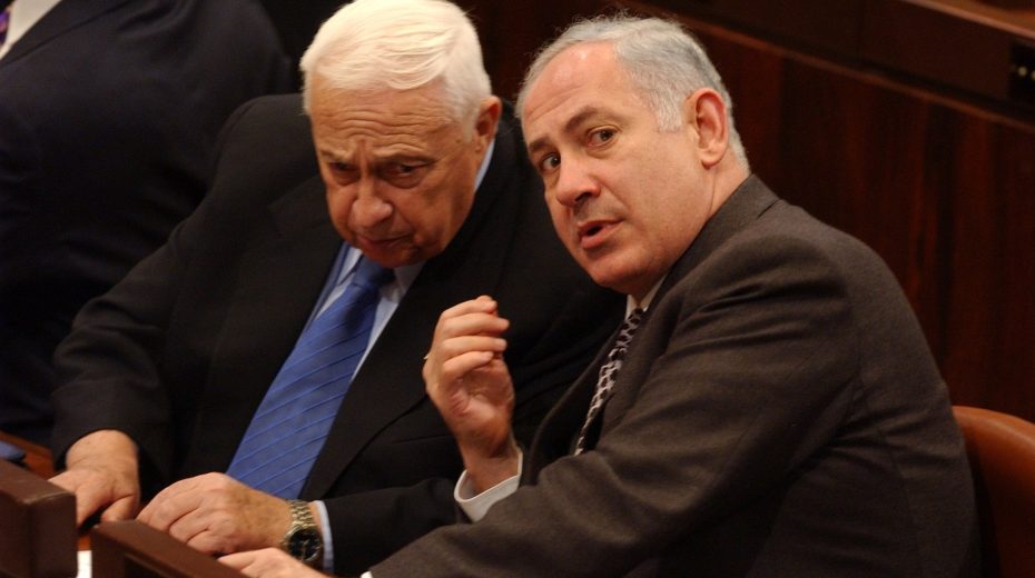 “Let go of the ego” Ariel Sharon and Benjamin Netanyahu conferring in the Knesset. A greater cause can sometimes help even politicians overcome egos and differences to unite. Photo by Flash90