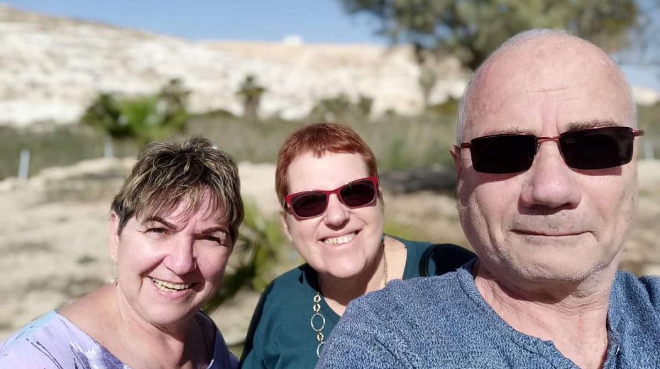 Elderly couple survive three Hamas assaults in Kibbutz Yitzhak Vivian Roitman (center) with her neighbors, Louis and Carla, who along with 3 other members of their family were kidnapped by Hamas terrorists and taken to the Gaza Strip on Oct. 7, 2023. Credit: Courtesy.