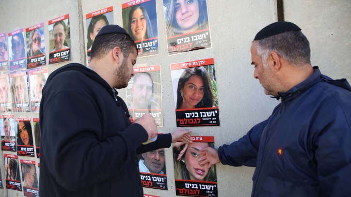 Orthodox Jews put up posters of the israelis held hostage by Hamas terrorists in Gaza, since October 7, at Rachel's Tomb, outside of Jerusalem. November 24, 2023. Photo by David Cohen/Flash90