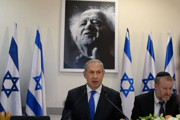 Prime Minister Benjamin Netanyahu stands in front of a portrait of israel’s first prime minister, David Ben-Gurion. (Photo: Kobi Gideon/GPO)