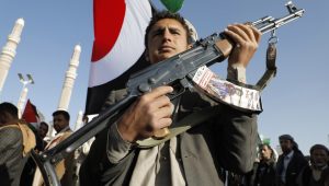 A man holds a gun during a protest against the recently announced operation to safeguard trade and to protect ships in the Red Sea, in Sana'a, Yemen, 22 December 2023. EPA-EFE/OSAMAH YAHYA