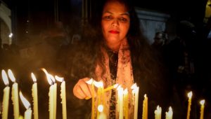 Christians in Jerusalem light candles on Christmas Eve. Photo by Jamal Awad/Flash90