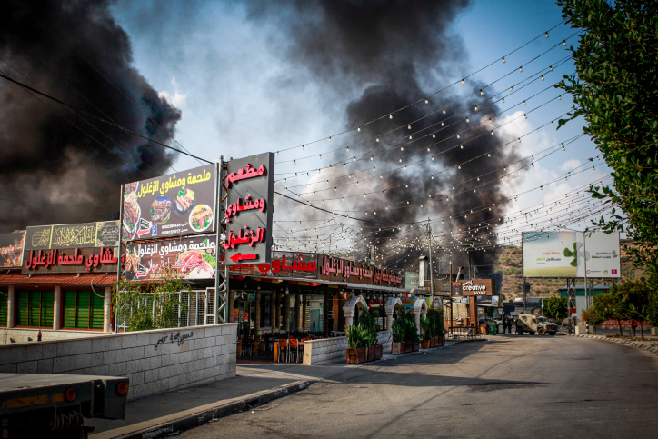 Smoke rises during a protest of Jewish settlers near the village of Deir Sharaf, west of the city of Nablus, in response to the shooting attack earlier today, November 2, 2023. Photo by Nasser Ishtayeh/Flash90