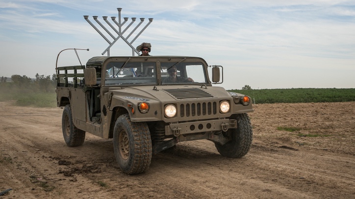 Israeli soldiers bring a Hanukkah menorah into Gaza. Photo by Flash90