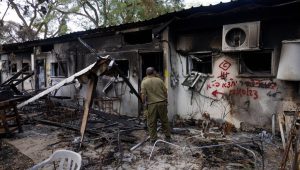 Israeli soldiers walking next to destruction caused by Hamas terrorists in Kibbutz Nir Oz, Nov. 21, 2023. Photo by Chaim Goldberg/Flash90.