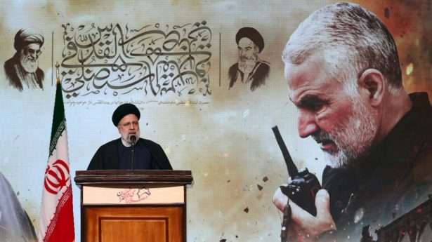 Iranian president Ebrahim Raisi speaks to the crowd in front of an image of the late Islamic Revolutionary Guard Corps (IRGC) Quds Force commander Qasem Soleimani during the fourth anniversary of his death. EPA-EFE/ABEDIN TAHERKENAREH