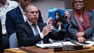 Gilad Erdan, Israeli ambassador to the United Nations, shows a photo Yahya Sinwar, Hamas’s chief in the Gaza Strip, holding a young child with an automatic weapon at a U.N. Security Council meeting on Nov. 22, 2023. Credit: Courtesy of Israeli Mission to the U.N.