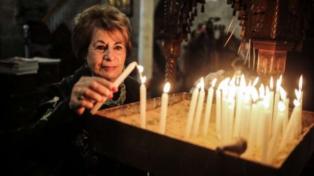 Palestinian Christians pray during Christmas Mass. Photo by Hassan Jedi/Flash90