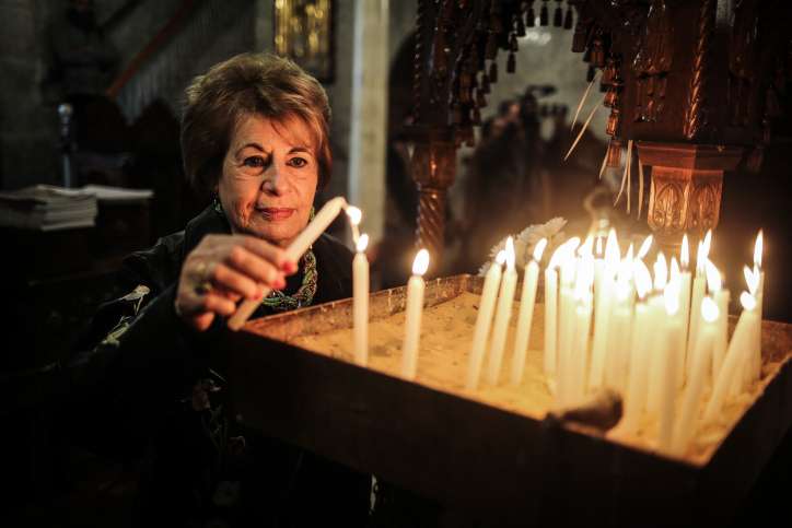 Palestinian Christians pray during Christmas Mass. Photo by Hassan Jedi/Flash90