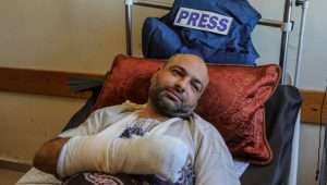 Palestinian photojournalist Ashraf Amra lying inside Nasser Medical Hospital after being hit by a gas bomb in his right hand by Israeli army soldiers near the border between Israel and Gaza, in the city of Khan Yunis, southern of Gaza Strip, on September 16, 2023. Photo by Abed Rahim Khatib/Flash90